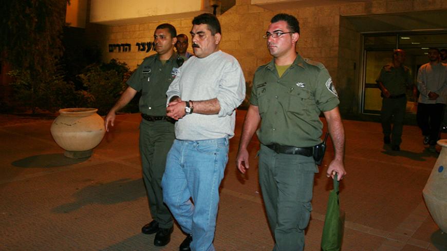 HADARIM PRISON, ISRAEL - JULY 16: In this handout image from Hadarim Prison, Lebanese prisoner Samir Kantar is released by Israeli prison guards on July 16, 2008 at the Hadarim Prison in central Israel.  Kuntar, who was jailed in Israel in 1979 at the age of 16 for murder and attempted murder,  was swapped in the UN mediated handover with soldiers Eldad Regev, 27, and Ehud Goldwasser, 32. (Photo by Hadarim Prison via Getty Images) *** Local Caption *** Samir Kantar