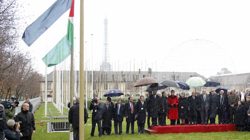 Palestinian President Mahmoud Abbas (C), UNESCO Director-General Irina Bokova and officials attend the flag raising ceremony for the Palestinian flag at UNESCO Headquarters in Paris December 13, 2011. The United Nations Educational Scientific and Cultural Organisation (UNESCO) became the first U.N. agency to welcome the Palestinians as a full member since President Mahmoud Abbas applied for full membership of the United Nations on September 23.  REUTERS/Benoit Tessier (France - Tags: POLITICS) - RTR2V6RT