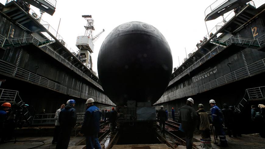 People attend a ceremony launching the diesel-electric submarine "Rostov-on-Don" at the Admiralty Shipyards in St. Petersburg, June 26, 2014. "Rostov-on-Don" produced under Project 636.3 is the second serial submarine being built by OJSC Admiralty Shipyards for Russia's Black Sea Fleet. REUTERS/Alexander Demianchuk (RUSSIA - Tags: MILITARY TPX IMAGES OF THE DAY) - RTR3VUFV