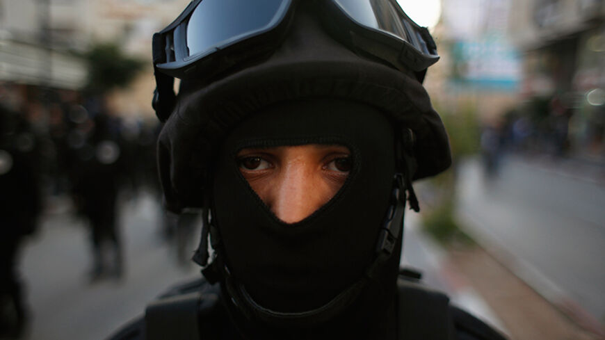 A member of Palestinian security forces takes part in a rally marking the 50th anniversary of the founding of the Fatah movement, in the West Bank city of Ramallah December 31, 2014. Palestinian President Mahmoud Abbas signed on to 20 international agreements on Wednesday, including the Rome Statute of the International Criminal Court, a day after a bid for independence by 2017 failed at the United Nations Security Council. REUTERS/Mohamad Torokman (WEST BANK - Tags: POLITICS) - RTR4JR7M