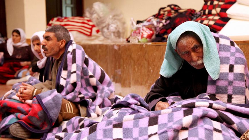 People from the minority Yazidi sect take refuge in a building in Shikhan January 19, 2015.  Islamic State has hounded ethnic and religious minorities in northern Iraq since seizing the city of Mosul in June, killing and displacing thousands of Christians, Shi'ite Shabaks and Turkmen who lived for centuries in one of the most diverse parts of the Middle East. Hundreds of Yazidi women and girls have been captured, raped and tortured, and forced to convert to Islam and marry Islamic State followers, according