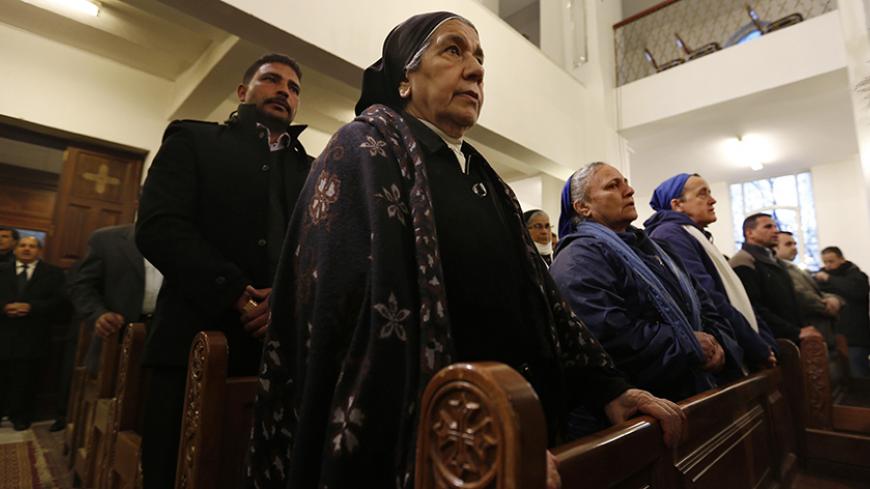 Jordanian Christians attend mass at the Coptic Orthodox Patriarchate in Amman, in memory of the Egyptians beheaded in Libya, February 18, 2015. Christians in Amman held the prayer service, which was attended by representatives of the churches in Jordan, for the Egyptian Christians beheaded by Islamic State in Libya last week. REUTERS/ Muhammad Hamed (JORDAN - Tags: POLITICS CIVIL UNREST CRIME LAW) - RTR4Q4Y0