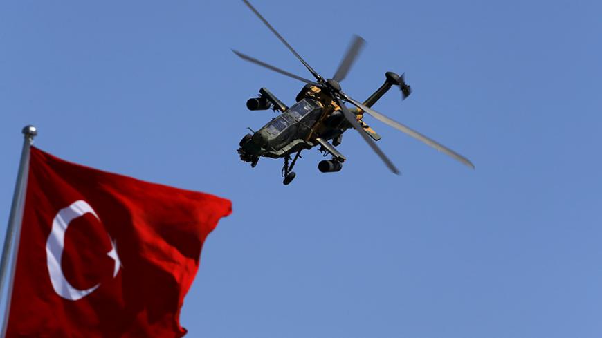 A Turkish Attack and Tactical Reconnaissance Helicopter (ATAK) performs a manoeuvre during a ceremony marking the 93rd anniversary of Victory Day in Ankara, Turkey, August 30, 2015. REUTERS/Umit Bektas - RTX1Q9Q7
