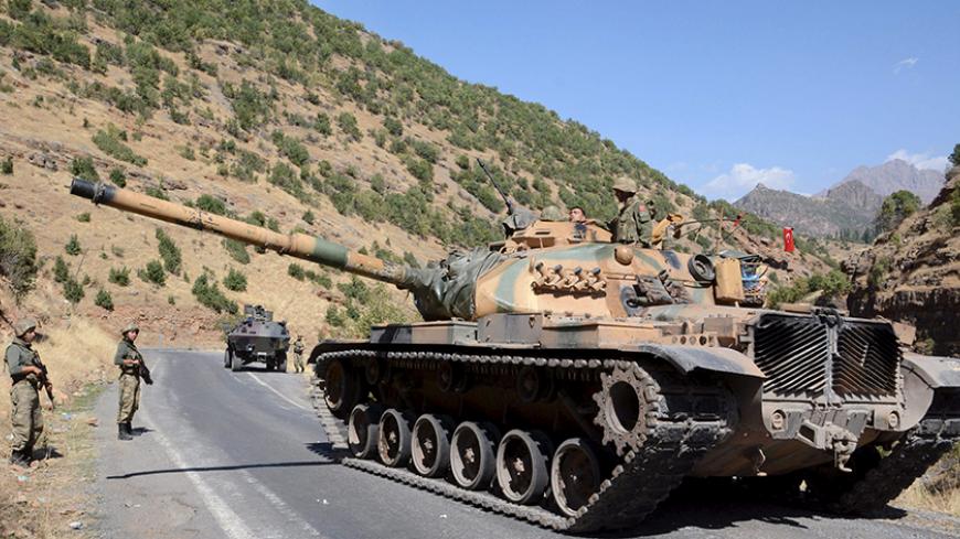 Turkish soldiers in a tank and an armored vehicle patrol on the road to the town of Beytussebab in the southeastern Sirnak province, Turkey, September 28, 2015. Five children were wounded on Monday when a bomb tore through a street in the Turkish city of Diyarbakir, hospital officials said, where deadly clashes in recent weeks have followed the collapse of ceasefire by Kurdish militants. A separate blast in the town of Tatvan wounded five soldiers when their vehicle passed over an explosive left in a ditch 