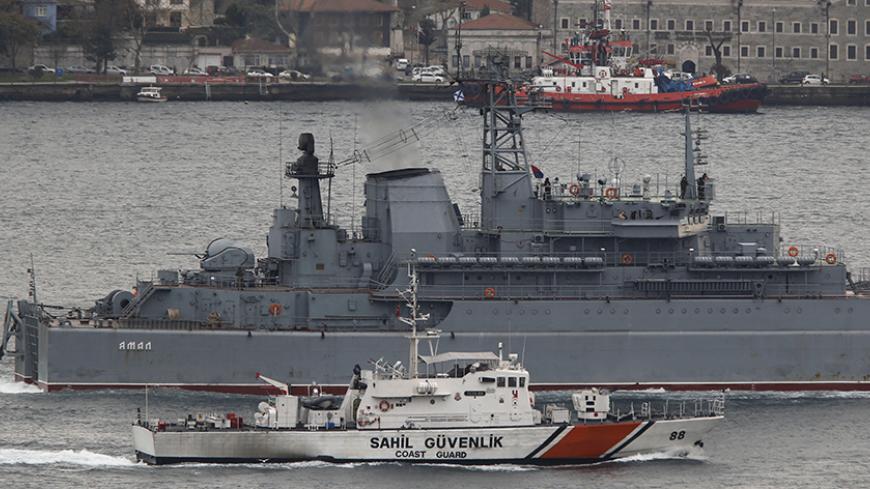 The Russian Navy large landing ship Yamal is escorted by a Turkish Navy Coast Guard boat as it sets sail in the Bosphorus, on its way to the Mediterranean Sea, in Istanbul, Turkey, December 9, 2015. REUTERS/Murad Sezer  - RTX1XWMH
