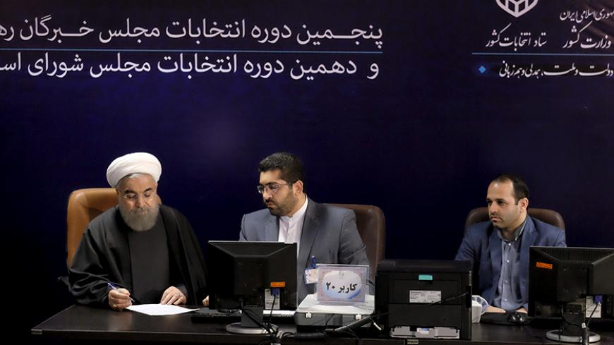Iranian President Hassan Rouhani (L) registers for February's election of the Assembly of Experts, the clerical body that chooses the supreme leader, at the Interior Ministry in Tehran December 21, 2015. REUTERS/Raheb Homavandi/TIMA ATTENTION EDITORS - THIS IMAGE WAS PROVIDED BY A THIRD PARTY. FOR EDITORIAL USE ONLY. - RTX1ZKJH