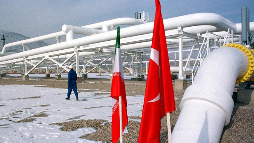 A worker walks past the pumping station on the border between Iran and Turkey during the innauguration ceremony for the Iran - Turkey gas pipeline  January 22, 2002. Iran could increase gas pumped to Turkey through a newly-opened pipeline to 13 billion cubic metres a year, above the 10 billion cubic metres planned. - RTXL0AM