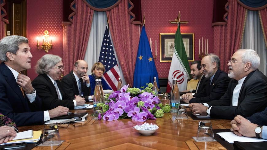 U.S. Secretary of State John Kerry (L), U.S. Secretary of Energy Ernest Moniz (2nd L), Head of the Iranian Atomic Energy Organisation Ali Akbar Salehi (2nd R) and Iranian Foreign Minister Javad Zarif (R) wait with others ahead of a meeting at the Beau Rivage Palace Hotel in Lausanne on March 26, 2015 during negotiations on the Iranian nuclear programme. REUTERS/Brendan Smialowski/Pool - RTR4UXKJ