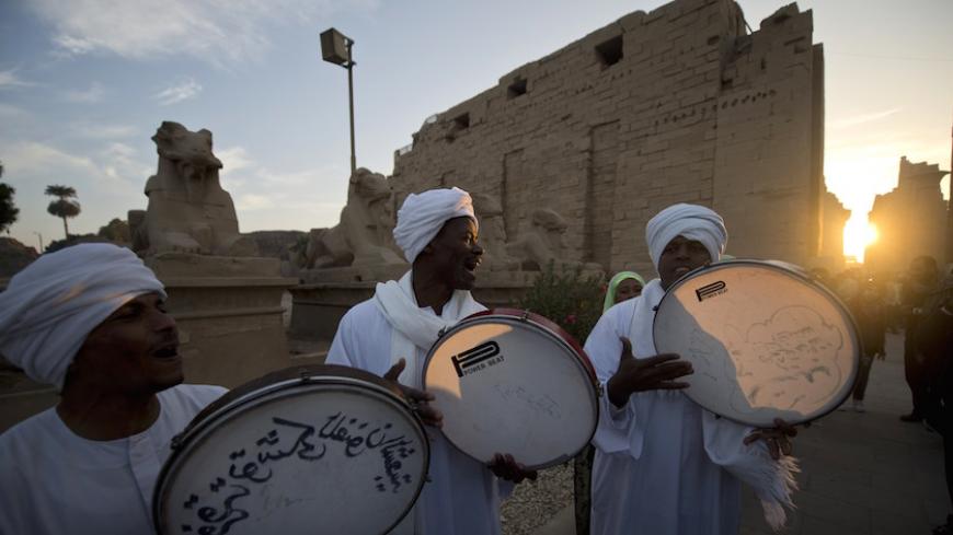 An Egyptian Nubian band performs traditional songs as they celebrate the aligned of the winter solstice sunrise to the Temple of Karnak, in the southern Egyptian city of Luxor on December 21, 2013. The central sector of the site which takes up the largest amount of space, is dedicated to the Egyptian god Amun, who became prominent as the greatest of the gods. AFP PHOTO / KHALED DESOUKI        (Photo credit should read KHALED DESOUKI/AFP/Getty Images)