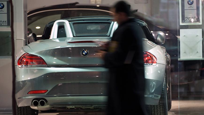 EDITORS' NOTE: Reuters and other foreign media are subject to Iranian restrictions on leaving the office to report, film or take pictures in Tehran.

An Iranian man walks past a BMW displayed at a car shop in central Tehran March 1, 2012. REUTERS/Morteza Nikoubazl (IRAN - Tags: SOCIETY BUSINESS TRANSPORT)