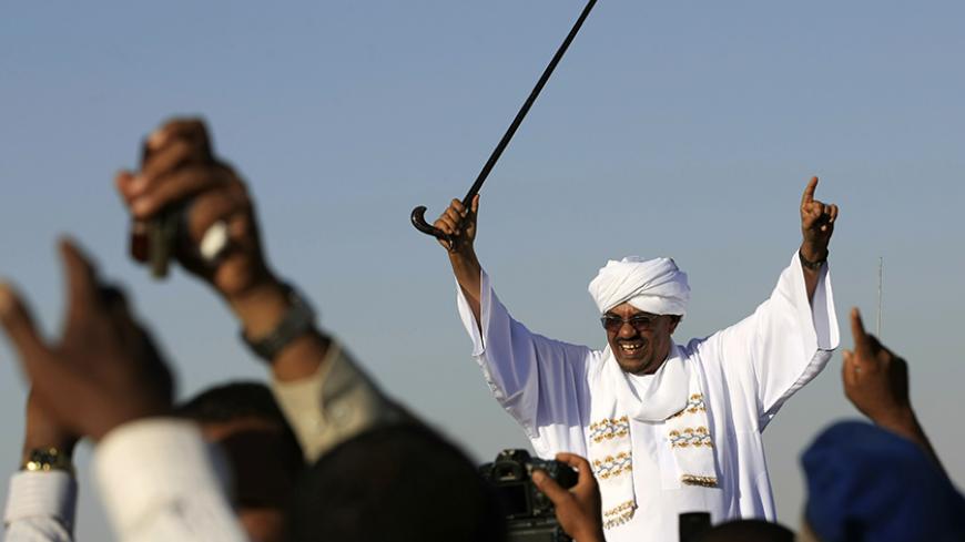 Sudan's President Omar al-Bashir waves to the crowd during his arrival from Saudi Arabia at Khartoum Airport after returning from vocal cord surgery in the kingdom November 14, 2012. REUTERS/Mohamed Nureldin Abdallah (SUDAN - Tags: POLITICS) - RTR3AEAX