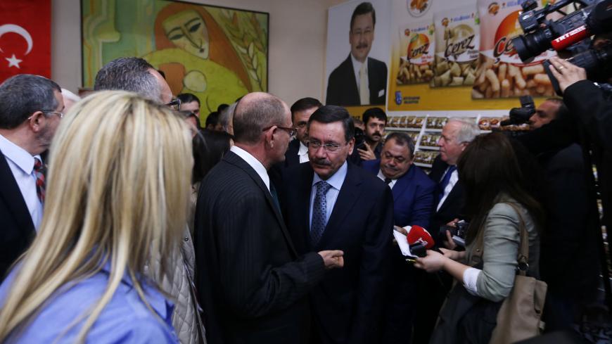 Turkey's ruling AK Party (AKP) mayoral candidate and current Ankara Mayor Melih Gokcek (C) attends an event as part of his election campaign in Ankara March 18, 2014.  The local elections will be the first concrete test of Prime Minister Tayyip Erdogan's popularity since anti-government protests rocked major cities last summer and the corruption scandal erupted in mid-December. The race for Ankara is set to be among the closest , with current mayor Melih Gokcek, an argumentative character known for fiery co
