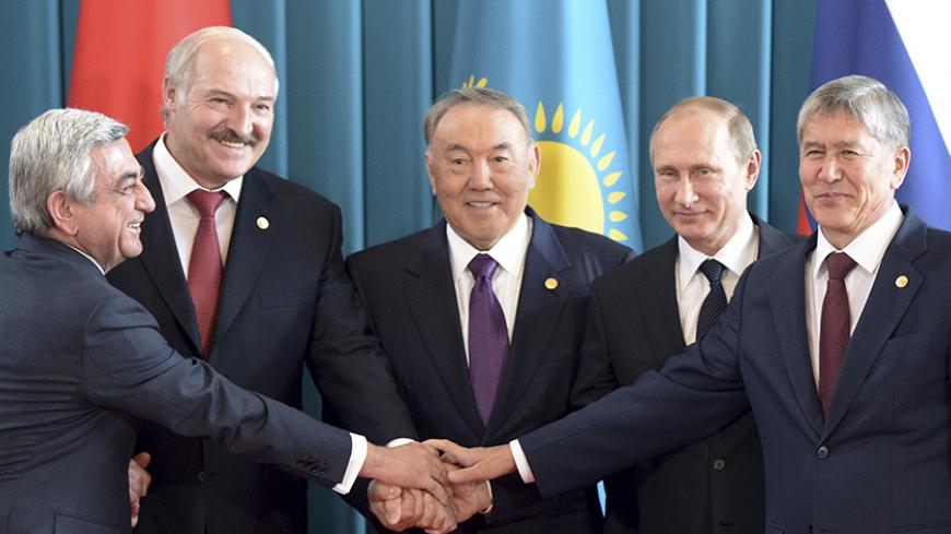 Armenia's President Serzh Sargsyan (L-R), Belarus' President Alexander Lukashenko, Kazakhstan's President Nursultan Nazarbayev, Russia's President Vladimir Putin and Kyrgyzstan's President Almazbek Atambayev pose for a family photo during a meeting of the heads of state of the Supreme Eurasian Economic Council at the Burabai resort near Astana, Kazakhstan, October 16, 2015. The meeting of ex-Soviet leaders, including Putin, have agreed to create a joint task force to defend external borders in crisis situat