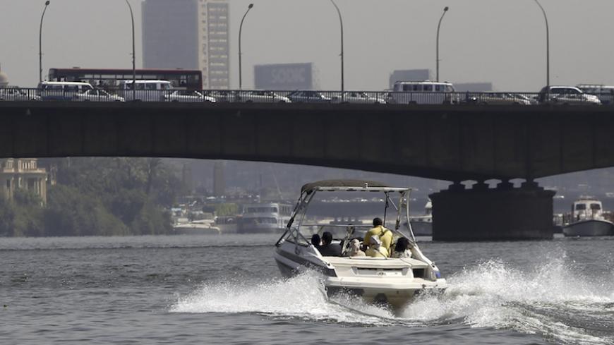 Passengers ride in a river taxi on the Egyptian Nile River in Cairo June 13, 2013. Despite owning their own vehicles, some commuters in Cairo are choosing to use the river taxis, which cost 30 Egyptian pounds ($4.30) each way, to avoid the traffic jams.    REUTERS/Amr Abdallah Dalsh  (EGYPT - Tags: TRANSPORT SOCIETY) - RTX10MG9