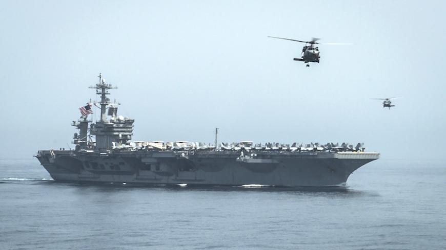 Helicopters fly from the aircraft carrier USS Theodore Roosevelt (CVN 71) during a resupply mission with the aircraft carrier USS Carl Vinson (CVN 70) in this U.S. Navy handout picture taken in the Gulf of Oman April 13, 2015 and released April 20, 2015. The U.S. Navy sent the carrier USS Theodore Roosevelt and its escort cruiser, USS Normandy, from the Gulf into the Arabian Sea on Sunday.  Army Colonel Steve Warren, a Pentagon spokesman, denied reports the ships were on a mission to intercept Iranian arms 