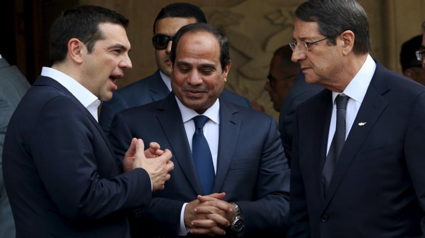 Egyptian President Abdel Fattah al-Sisi (C), Cypriot President Nicos Anastasiades (R) and Greek Prime Minister Alexis Tsipras chat outside the Presidential Palace in Nicosia, April 29, 2015. Greece will launch consultations with Egypt and Cyprus to establish maritime boundaries in the eastern Mediterranean, Tsipras said on Wednesday.  REUTERS/Yiannis Kourtoglou

 - RTX1ATIB