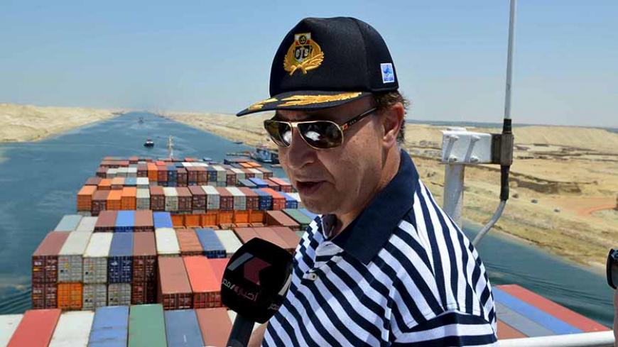 Mohab Mameesh, chairman of the Suez Canal Authority ,talks to state TV as he checks work at the New Suez Canal, Ismailia, Egypt, July 25, 2015. The first cargo ships passed through Egypt's New Suez Canal on Saturday in a test-run before it opens next month, state media reported, 11 months after the army began constructing the $8 billion canal alongside the existing 145-year-old SuezCanal. Mameesh told state television that this test-run had been a success and that more would follow.
REUTERS/Stringer - RTX1L