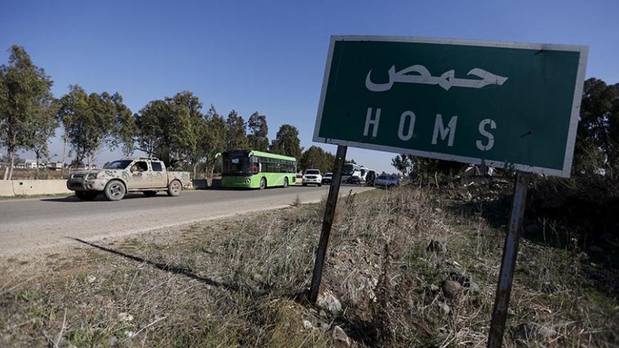 Buses leave district of Waer during a truce between the government and rebels, in Homs, Syria December 9, 2015. Scores of people left the last area held by insurgents in the Syrian city of Homs on Wednesday under a local truce between the government and rebels, a monitoring group said, a rare agreement in Syria's nearly five-year conflict. Three buses carrying people had left the previously besieged district of Waer, the Syrian Observatory for Human Rights said. About 750 people were expected to leave durin