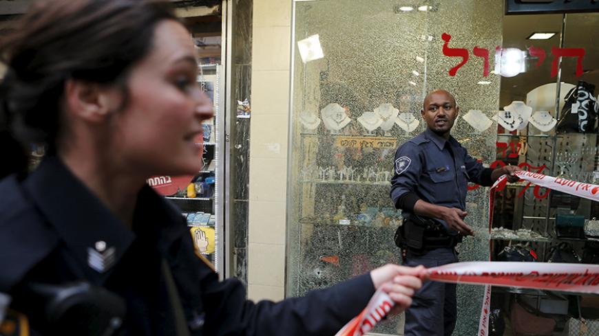 Israeli police officers cordon off the scene of a shooting incident in Tel Aviv, Israel January 1, 2016. One person was killed and several were wounded in a shooting incident in central Tel Aviv on Friday, Israeli media said. A police spokesman confirmed there had been several casualties but would not say if anyone was killed in the incident on Dizengoff Street. REUTERS/Nir Elias  - RTX20PRI