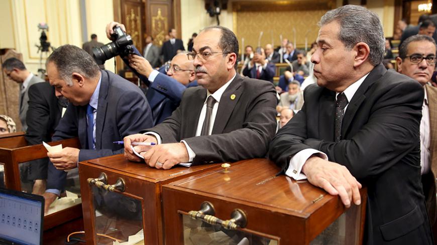 Tawfik Okasha (R), looks onvote to choose the head of the Egypt's Parliament late in Sunday's procedural and opening session at the main headquarters of Parliament in Cairo, Egypt, January 10, 2016. Meeting for the first time in more than three years, Egypt's new parliament on Sunday elected a constitutional expert as its speaker, a key position as President Abdel Fattah al-Sisi looks to push through more than 200 laws issued by executive decree while the assembly was suspended. REUTERS/Stringer - RTX21RGV