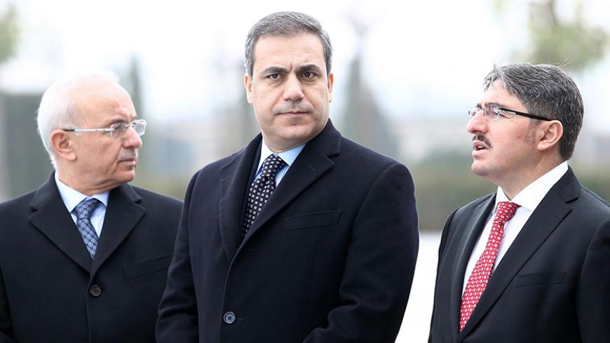 This file picture taken on December 19, 2014 shows the head of Turkey's intelligence agency Hakan Fidan (C) standing in Ankara. The powerful head of Turkey's intelligence agency, one of the most loyal allies of President Recep Tayyip Erdogan, has resigned to stand for election as a lawmaker, the official Anatolia news agency said on February 7, 2015. The resignation of Hakan Fidan, who has headed the National Intelligence Agency (MIT) since 2010, has been accepted by Prime Minister Ahmet Davutoglu and will 