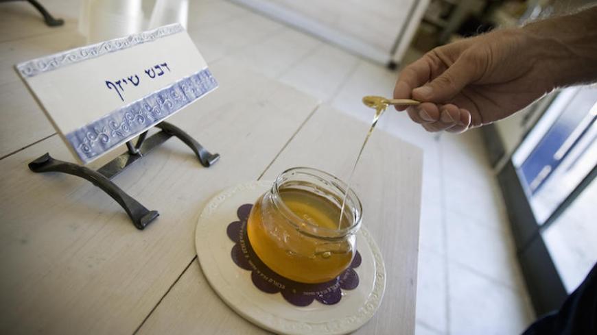 TO GO WITH AFP STORY BY GAVIN RABINOWITZ
An Israeli man tastes honey at a store in the town of Kfar Ruth near Tel Aviv on September 10, 2009. In recent years the Israeli taste for honey has been gradually changing -- it is no longer viewed just as a sweetener or a ceremonial condiment, but as a fine food to be explored and savoured, much like a good wine. AFP PHOTO/JONATHAN NACKSTRAND (Photo credit should read JONATHAN NACKSTRAND/AFP/Getty Images)