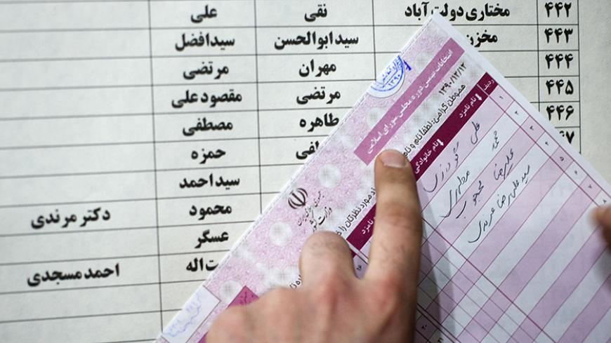 EDITORS' NOTE: Reuters and other foreign media are subject to Iranian restrictions on leaving the office to report, film or take pictures in Tehran.
A man fills in his ballot during Iran's parliamentary election, at a mosque in southern Tehran March 2, 2012. Iranians voted on Friday in a parliamentary election likely to reinforce Supreme Leader Ayatollah Ali Khamenei's power over rival hardliners led by President Mahmoud Ahmadinejad.   REUTERS/Raheb Homavandi  (IRAN - Tags: POLITICS ELECTIONS) - RTR2YQLW