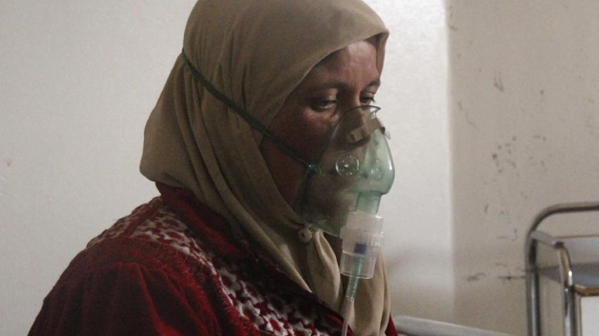 A woman, affected by what activists say was a gas attack, breathes through an oxygen mask inside a field hospital in Kfar Zeita village in the central province of Hama April 12, 2014. Syrian opposition activists have posted photographs and video that they say shows an improvised chlorine bomb to back up claims that President Bashar al-Assad's forces used chemical weapons in two attacks last week. Rebels and the government have blamed each other for the alleged poison gas attacks on Friday and Saturday on re