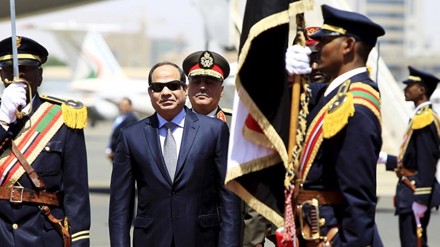 Egyptian President Abdel Fattah al-Sisi (C) inspects a guard of honour upon his arrival at Khartoum Airport, ahead of a signing ceremony of an Agreement on Declaration of Principles between Sudan, Egypt and Ethiopia on the Grand Ethiopian Renaissance Dam Project, in Khartoum March 23, 2015.  The leaders of Egypt, Ethiopia and Sudan signed a cooperation deal on Monday over a giant Ethiopian hydroelectric dam on a tributary of the river Nile, in a bid to ease tensions over regional water supplies. The leaders