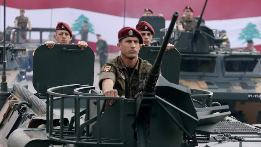 Lebanese Army soldiers on their military vehicles take part in a military parade to celebrate the 70th anniversary of Lebanon's independence, in downtown Beirut November 22, 2013. REUTERS/Mohamed Azakir (LEBANON - Tags: ANNIVERSARY POLITICS MILITARY) - RTX15OH2