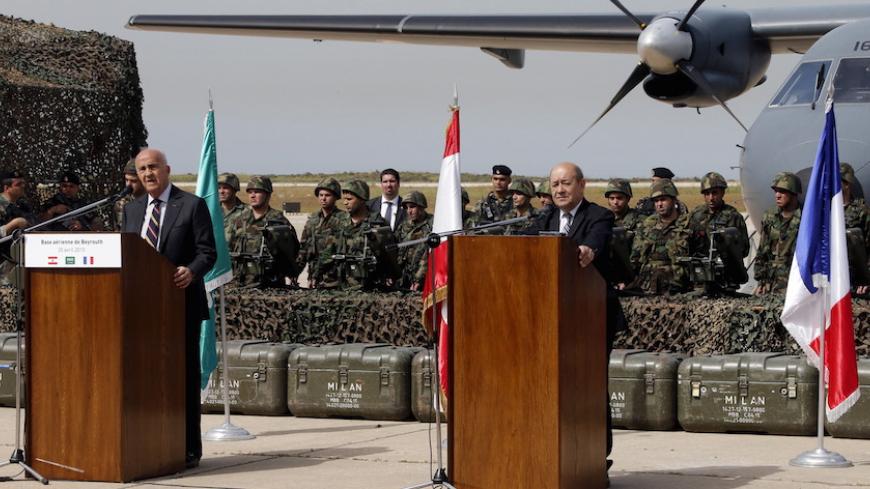 Lebanese Deputy Prime Minister and Defense Minister Samir Moqbel (L) speaks during a joint news conference with French Defense Minister Jean-Yves Le Drian at Beirut airport airbase during a ceremony to give weapons to the Lebanese army April 20, 2015. The first shipment of French weapons and military equipment arrived in Lebanon on Monday under a Saudi-funded deal worth $3 billion to bolster the Lebanese army's fight against militants encroaching from neighboring Syria. REUTERS/Mohamed Azakir  - RTX19GVB