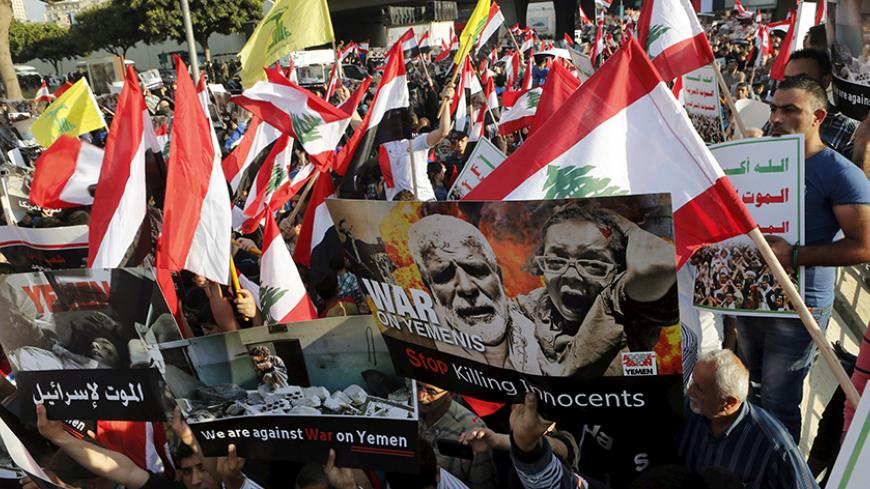 Protesters carry banners and wave Lebanese, Yemeni and Hezbollah flags during a protest against Saudi-led air strikes on Yemen, in front of the offices of the U.N. headquarters in Beirut May 12, 2015. Saudi-led air strikes pounded the rebel-held Yemeni capital Sanaa on Tuesday just hours before a five-day humanitarian ceasefire was set to begin. REUTERS/Mohamed Azakir - RTX1CNBR