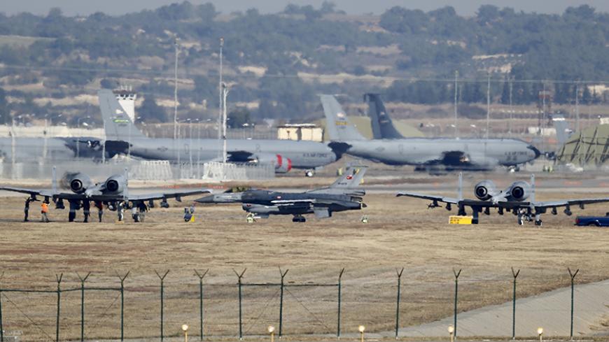 A Turkish Air Force F-16 fighter jet ( C foreground) is seen between U.S. Air Force A-10 Thunderbolt II fighter jets at Incirlik airbase in the southern city of Adana, Turkey, December 11, 2015. REUTERS/Umit Bektas - RTX1Y843