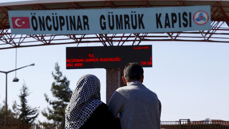 Two Syrians wait on the Turkish side of the Oncupinar border crossing for their parents to arrive from Syria, on the Turkish-Syrian border in the southeastern city of Kilis, Turkey, February 8, 2016. REUTERS/Osman Orsal    TPX IMAGES OF THE DAY      - RTX25Y24