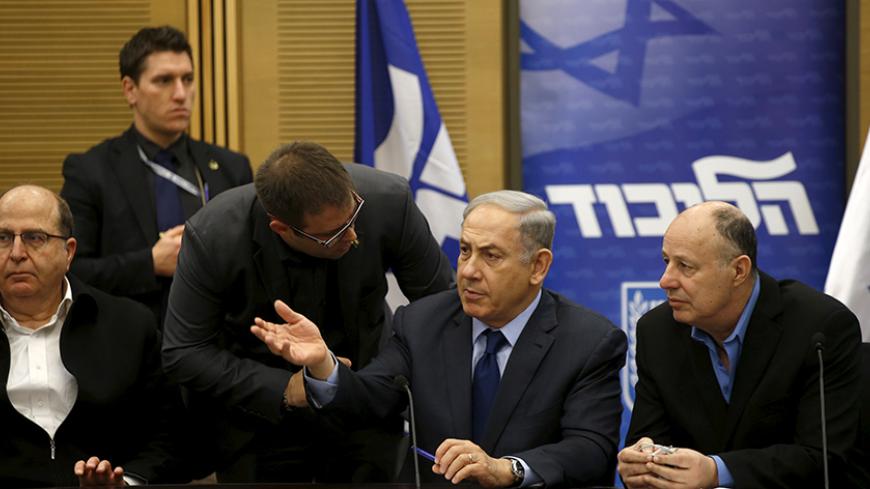 Israel's Prime Minister Benjamin Netanyahu (C) chats with members of his party during a meeting of his Likud party meeting in the Israeli parliament in Jerusalem February 8, 2016. A bill that opponents say targets Israeli human rights groups critical of Israel's policies towards the Palestinians was set to win initial approval in parliament on Monday with the support of the country's right-wing. It is widely expected to receive preliminary approval in the Knesset late on Monday.   REUTERS/Ronen Zvulun - RTX