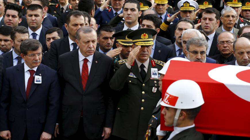 Turkish President Tayyip Erdogan (2nd L), Prime Minister Ahmet Davutoglu (L) and Turkish Army Chief of Staff General Hulusi Akar (3rd L) look on as honour guard carry the flag-draped coffin of Army officer Seckin Cil during a funeral ceremony in Ankara, Turkey, February 18, 2016. Army officer Seckin Cil was killed during the clashes between Turkish security forces and Kurdish militants in Sur district of the southeastern city of Diyarbakir. REUTERS/Umit Bektas - RTX27J7E