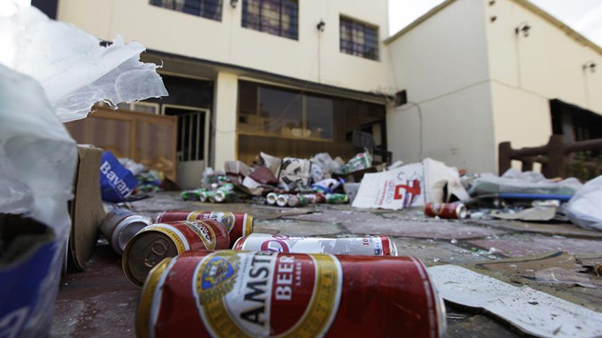 Beer cans are seen on the ground at the Ashurbanipal cultural society in Baghdad after an attack January 16, 2011. Men armed with steel pipes last week raided the Christian social club boasting a bar, and vandalized liquor shops in Baghdad, raising fears of a creeping fundamentalism as Iraq's new government gets to work. Picture taken January 16, 2011.  REUTERS/Saad Shalash (IRAQ - Tags: CIVIL UNREST RELIGION) - RTXWPQJ