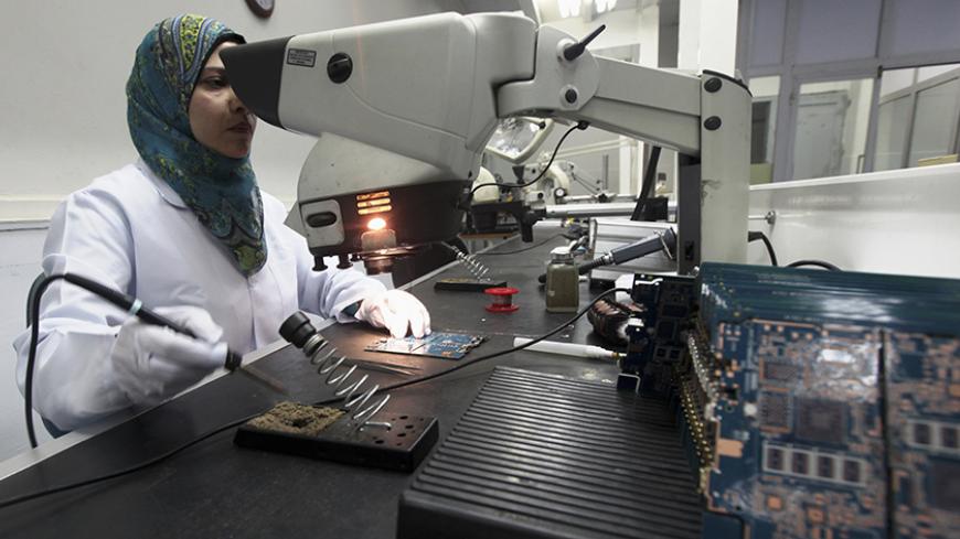 A worker checks Egypt's first tablet computer "Inar" in Benha May 18, 2013. Egypt has produced its very first tablet computer "Inar", part of a national project to distribute the device to students in schools and universities around the country. The Ministry of Military Production in collaboration with the Ministry of Communications presented the scheme last year to Benha Electronics Company known as 'Katron' to manufacture the tablet. Picture taken May 18, 2013.    REUTERS/Mohamed Abd El Ghany (EGYPT - Tag