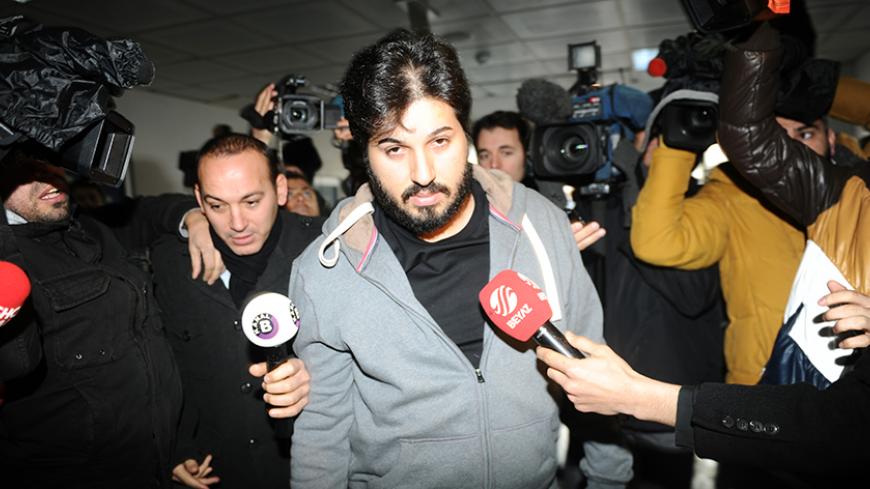 Detained Azerbaijani businessman Reza Zarrab (C) is surrounded by journalists as he arrives at a police center in Istanbul on December 17 ,2013. Turkish police detained more than 20 people including the sons of three cabinet ministers and several high-profile businessmen on December 17 in a probe into alleged bribery and corruption, local media reported. Prime Minister Recep Tayyip Erdogan's ruling Justice and Development Party (AKP), which boasts of being pro-business, has pledged to root out corruption, a