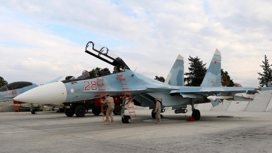 Russian servicemen prepare a Russian Sukhoi Su-30SM fighter jet before a departure for a mission at the Russian Hmeimim military base in Latakia province, in the northwest of Syria, on December 16, 2015.  
Russia began its air war in Syria on September 30, conducting air strikes against a range of anti-regime armed groups including US-backed rebels and jihadist groups. Moscow has said it is fighting and other "terrorist groups," but its campaign has come under fire by Western officials who accuse the Kremli