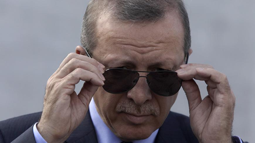 Turkey's President Recep Tayyip Erdogan adjusts his sunglasses before a wreath-laying ceremony at the Jose Marti monument in Havana February 11, 2015. Erdogan is in Cuba for an official visit. REUTERS/Enrique De La Osa (CUBA - Tags: POLITICS) - RTR4P6U8