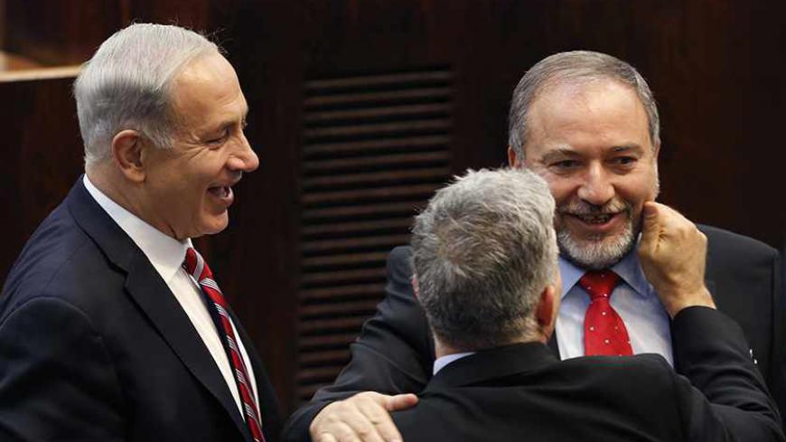 Israel's Prime Minister Benjamin Netanyahu (L) and Finance Minister Yair Lapid (back to camera) congratulate Israeli far-right leader Avigdor Lieberman after he was sworn in as Israel's Foreign Minister at the parliament in Jerusalem November 11, 2013. Lieberman was sworn in as foreign minister on Monday after his acquittal on corruption charges, a development that could further complicate peace talks with the Palestinians. REUTERS/Amir Cohen (JERUSALEM - Tags: POLITICS TPX IMAGES OF THE DAY) - RTX159MP