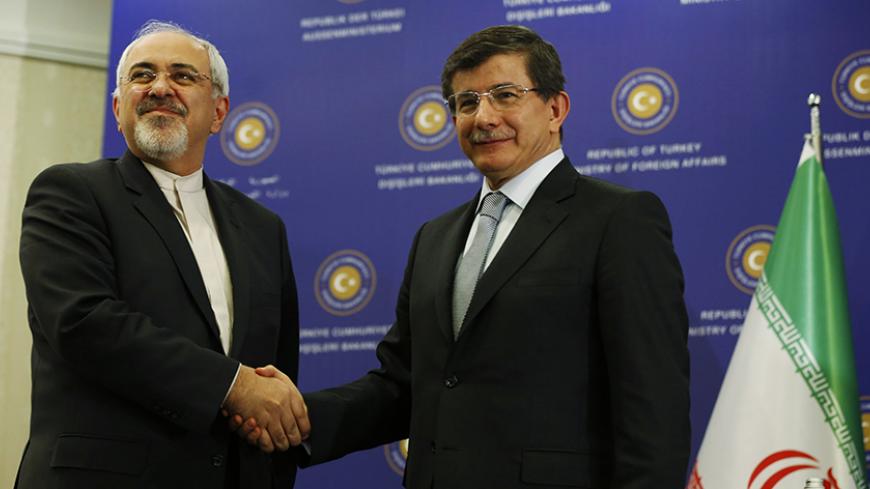Iran's Foreign Minister Mohammad Javad Zarif (L) shakes hands with his Turkish counterpart Ahmet Davutoglu during a joint news conference in Istanbul January 4, 2014. REUTERS/Murad Sezer (TURKEY - Tags: POLITICS) - RTX1724F