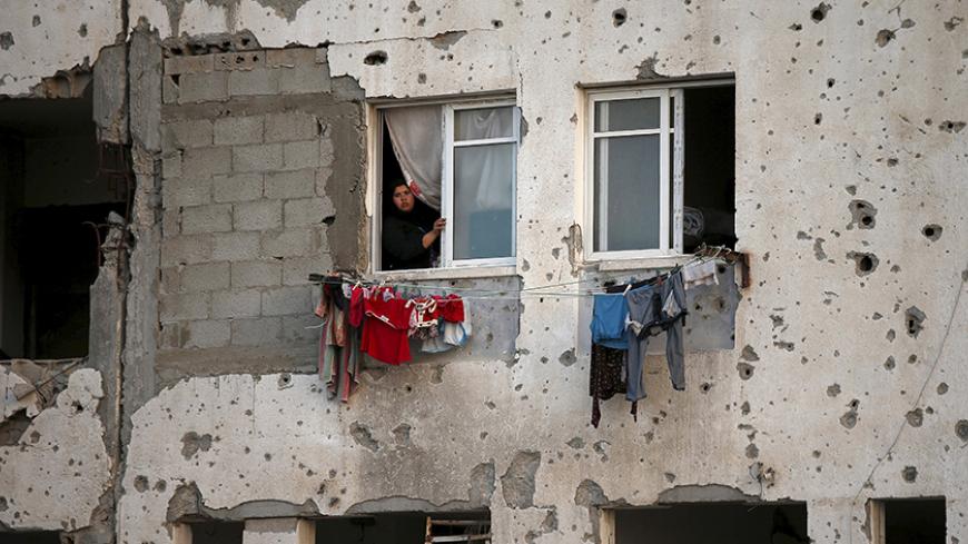 A Palestinian woman looks out her apartment in a residential buildings, that witnesses said was heavily damaged by Israeli shelling during a 50-day war last summer, in Beit Lahiya town in the northern Gaza Strip May 25, 2015. REUTERS/Suhaib Salem 







      TPX IMAGES OF THE DAY      - RTX1EI6U