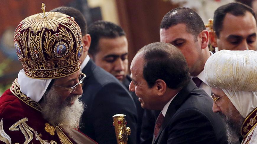 Egypt's President Abdel Fattah al-Sisi (R) greets Pope Tawadros II (L), the 118th Pope of the Coptic Orthodox Church of Alexandria and Patriarch of the See of St. Mark Cathedral, during Egypt's Coptic Christmas eve mass in Cairo, Egypt, January 6, 2016. REUTERS/Amr Abdallah Dalsh - RTX21BTB