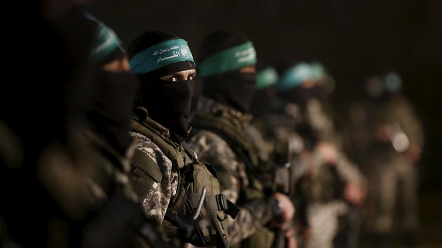 Palestinian Hamas militants stand guard during a rally in memory of their seven comrades, who were killed when a tunnel collapsed close to the Gaza Strip's eastern border with Israel, in the east of Gaza City January 31, 2016. REUTERS/Mohammed Salem  - RTX24TSC