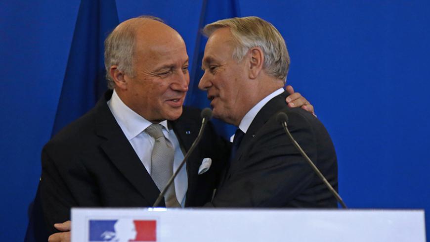 Outgoing French Foreign Minister Laurent Fabius (L) embraces newly-appointed Foreign Minister Jean-Marc Ayrault during the official handover ceremony at the Quai d'Orsay, Ministry of Foreign Affairs, in Paris, France, February 12, 2016.   REUTERS/Jacky Naegelen - RTX26NQI