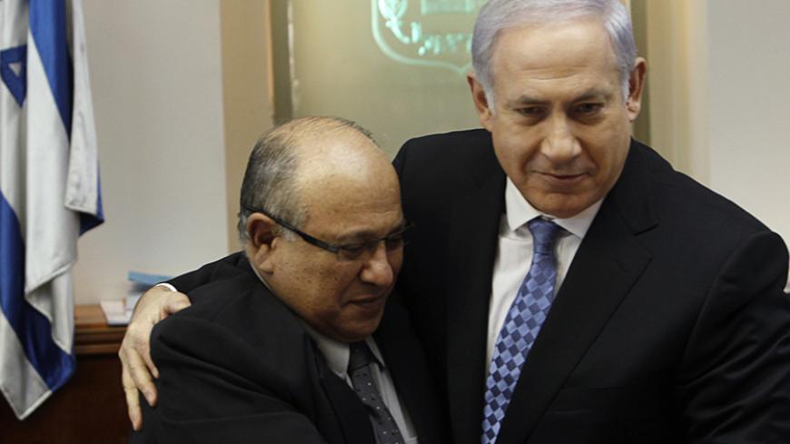 Israel's Prime Minister Benjamin Netanyahu (R) hugs Meir Dagan, the outgoing director of Israel's spy agency Mossad, after thanking him at the beginning of the weekly cabinet meeting in Jerusalem January 2, 2011. REUTERS/Ronen Zvulun (JERUSALEM - Tags: POLITICS) - RTXW5J6