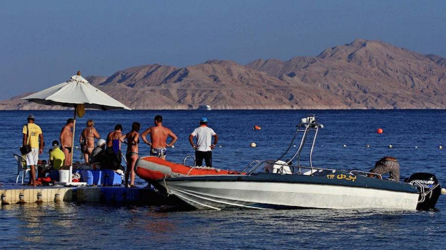 (FILE) A picture taken on November 12, 2015 from the Egyptian Red Sea resort of Sharm el-Sheikh shows tourists preparing to board a boat in front the Tiran island in the Strait of Tiran between Egypt's Sinai Peninsula and Saudi Arabia.
Saudi King Salman on April 11, 2016 wrapped up a landmark five-day visit to Egypt marked by lavish praise and multi-billion-dollar investment deals, in a clear sign of support for President Abdel Fattah al-Sisi's regime. Egypt also agreed during the visit to demarcate its mar