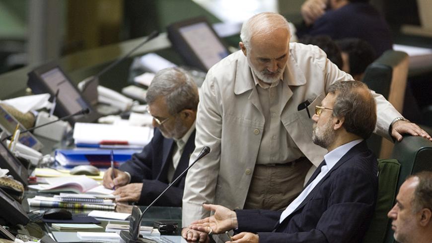 EDITORS' NOTE: Reuters and other foreign media are subject to Iranian restrictions on their ability to film or take pictures in Tehran.

Speaker of Parliament Ali Larijani (2nd R) talks to lawmaker Ahmad Tavakoli in parliament in Tehran August 31, 2009. REUTERS/Morteza Nikoubazl (IRAN POLITICS) - RTR27ADD